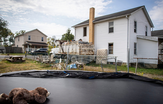 CORRECTION Infants Remains-Woman Charged