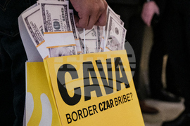 Activists Expose Border Czar with Cava "Bribe Bags"
