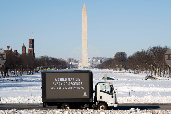 Oxfam mobile billboard in DC marks one year of President Trump's humanitarian aid and USAID cuts