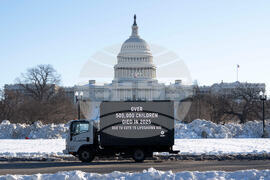 Oxfam mobile billboard in DC marks one year of President Trump's humanitarian aid and USAID cuts
