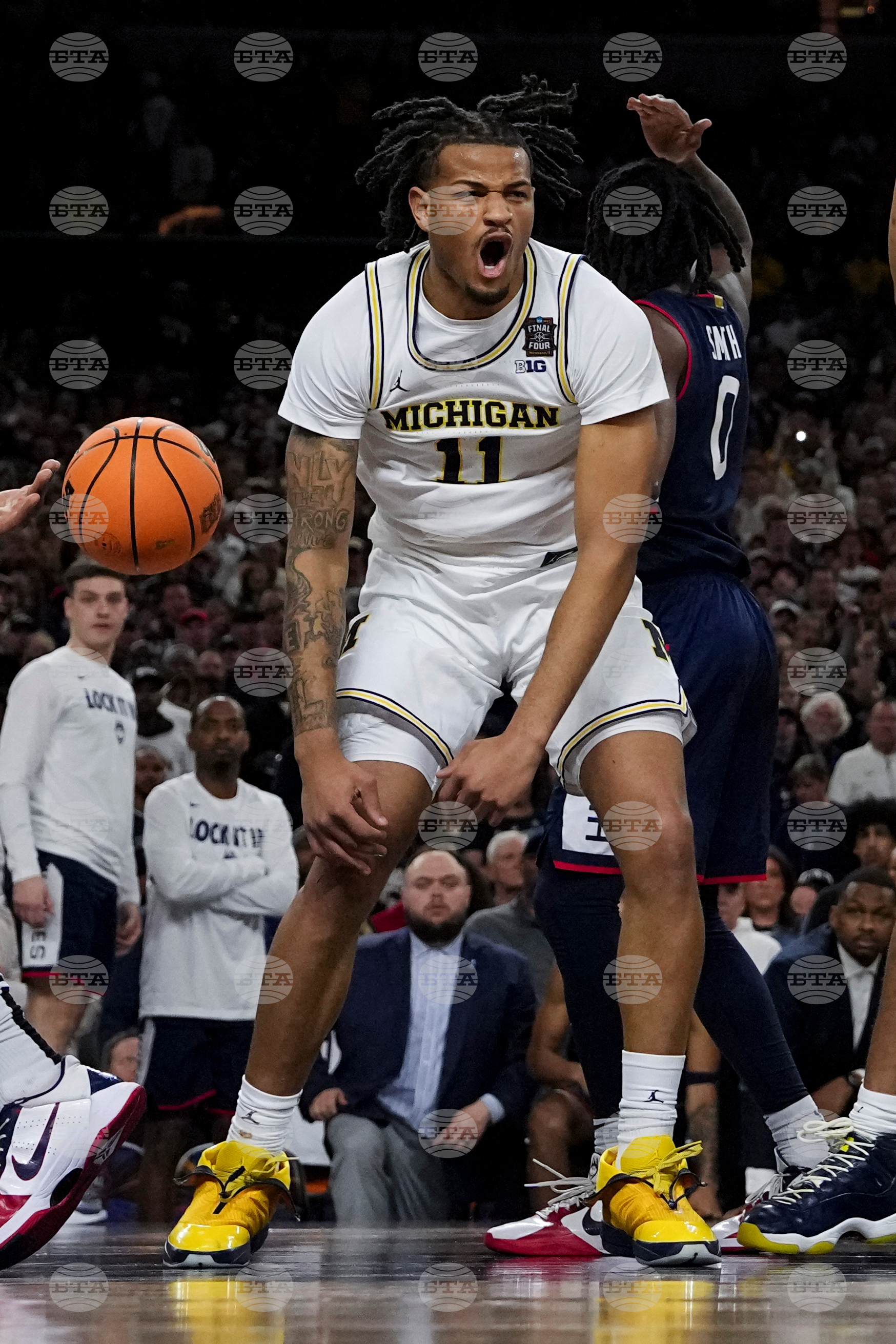 APTOPIX NCAA UConn Michigan Basketball