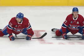 Montreal Canadiens' Alex Newhook (15) checks New Jersey Devils' Max Willman  (46) into the boards during first-period preseason NHL hockey game action  in Montreal, Monday, Sept. 25, 2023. (Christinne Muschi/The Canadian Press